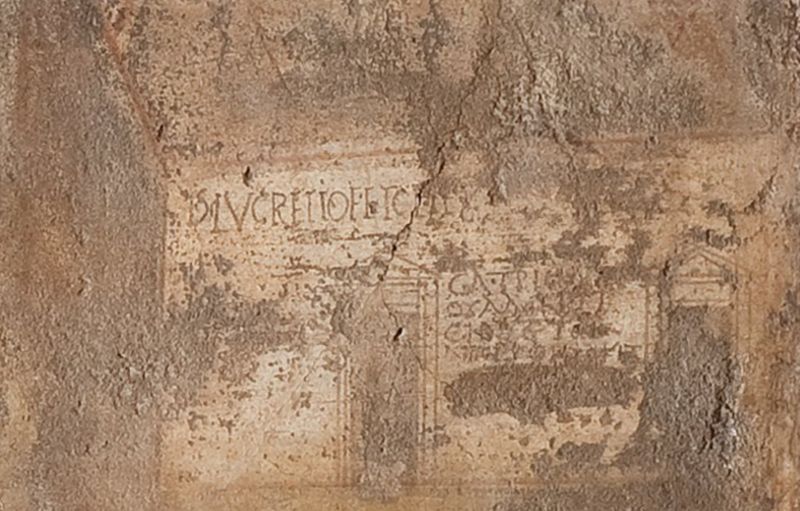 Detail from lower right part of fig. 2, showing feliciter acclamations written 
in Latin and Greek on northern façade of Large Palaestra